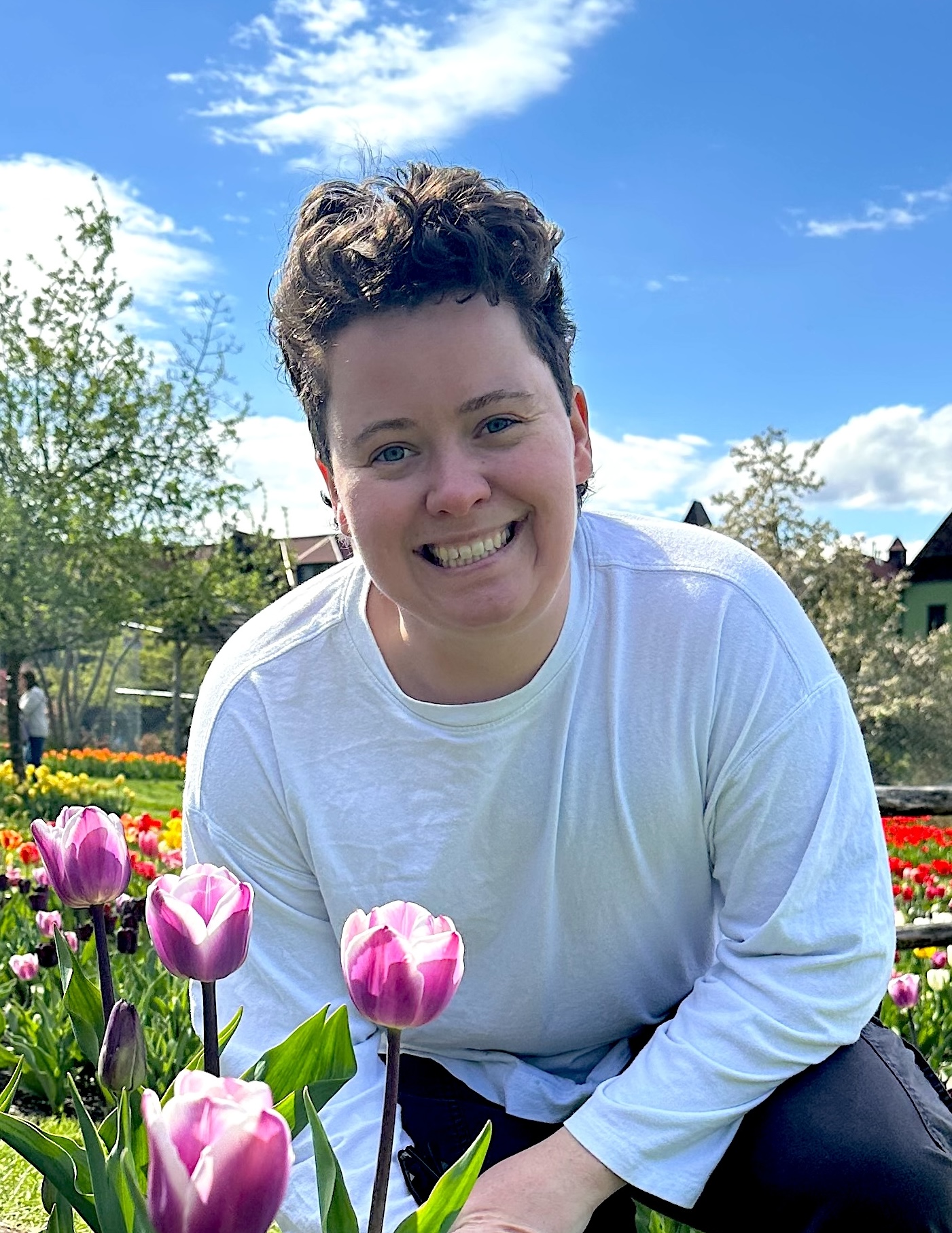 Erin Livingston in a tulip garden, smiling at the camera